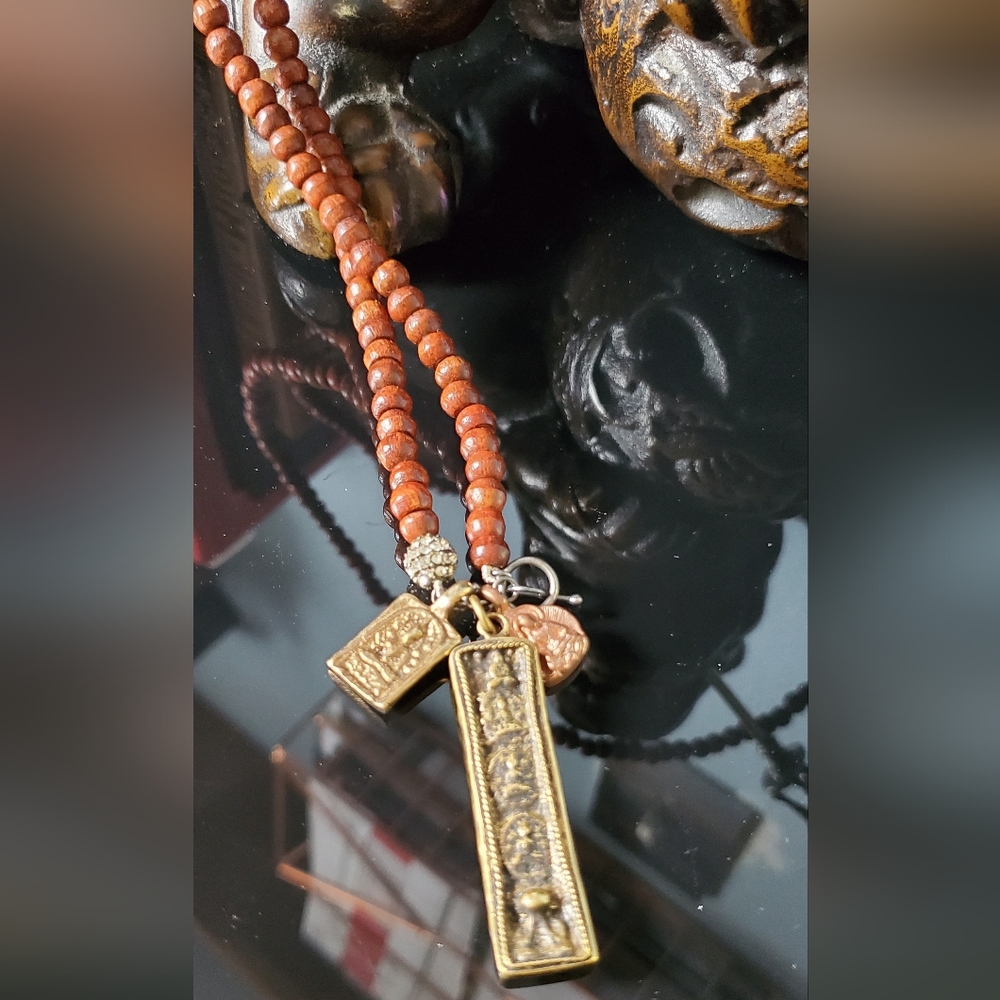 Retired Stella and Dot Awakening necklace Buddhist charms and wood beads 17" in